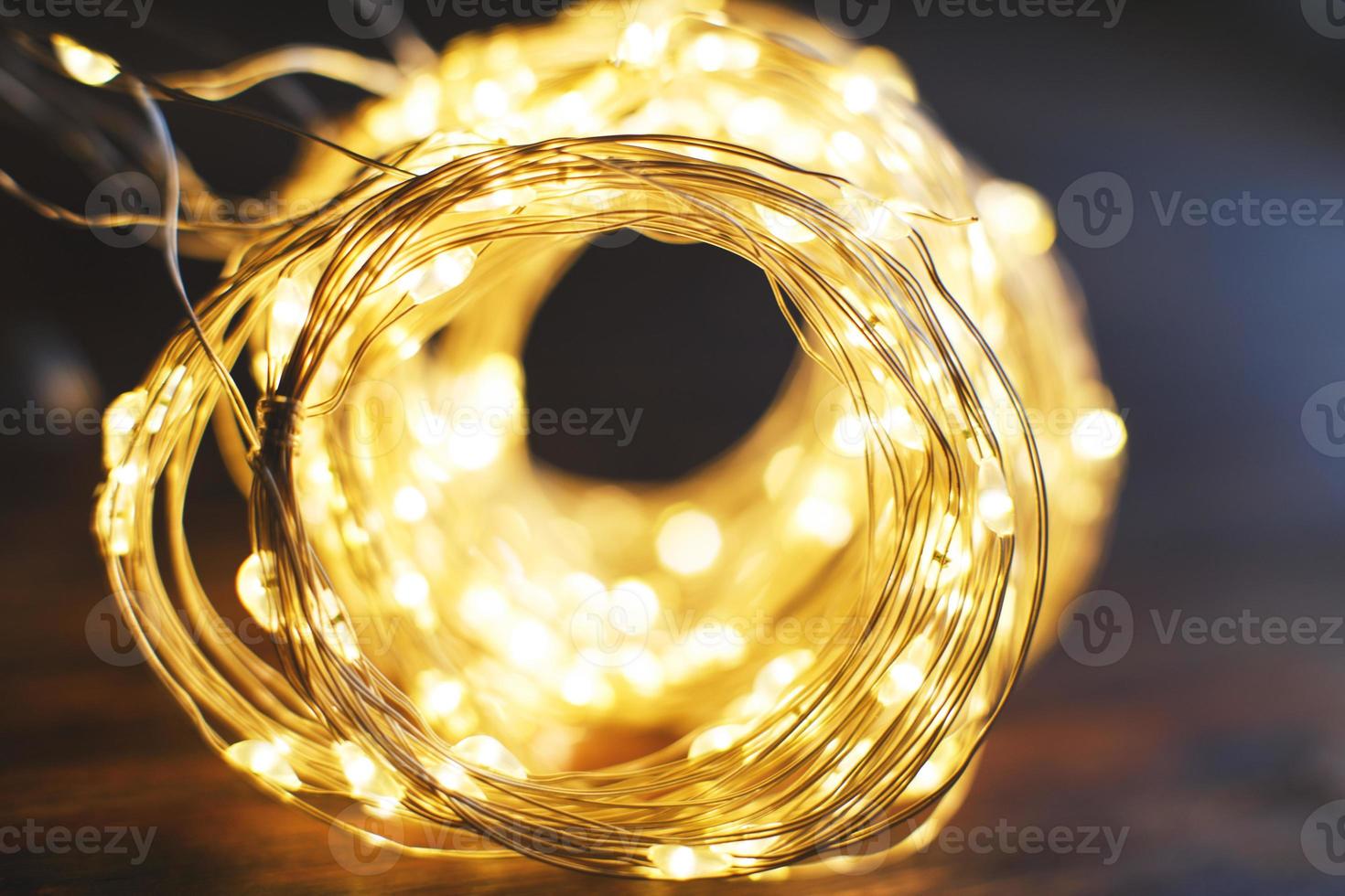 christmas beautifull shiny gold garland on a wooden brown background. sparkle festive background photo