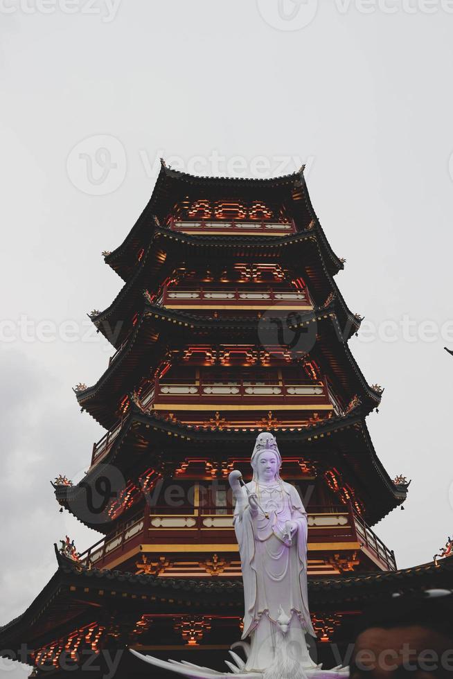 A Pagoda in the center of a Chinatown with the statue of Guan Yin. photo