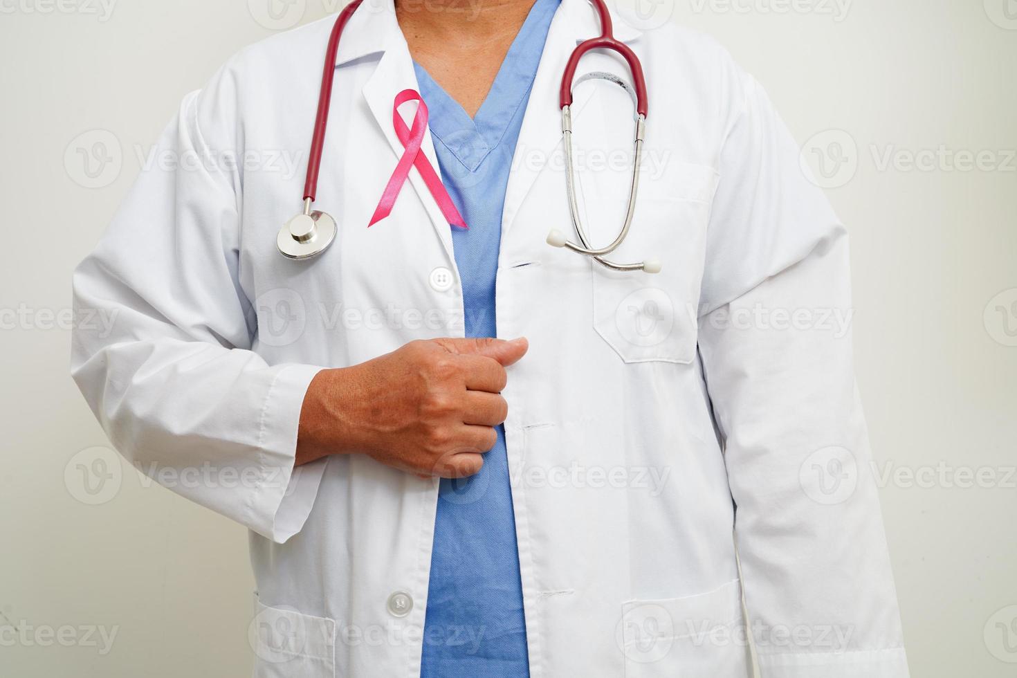 Asian woman doctor with pink ribbon, World Breast Cancer Day at October. photo