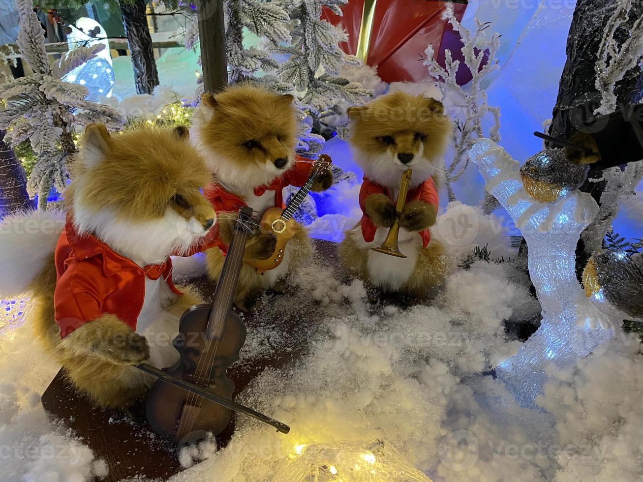 Christmas and New Year Decoration. Musical ensemble of toy foxes under the Christmas tree. New Year concepts photo