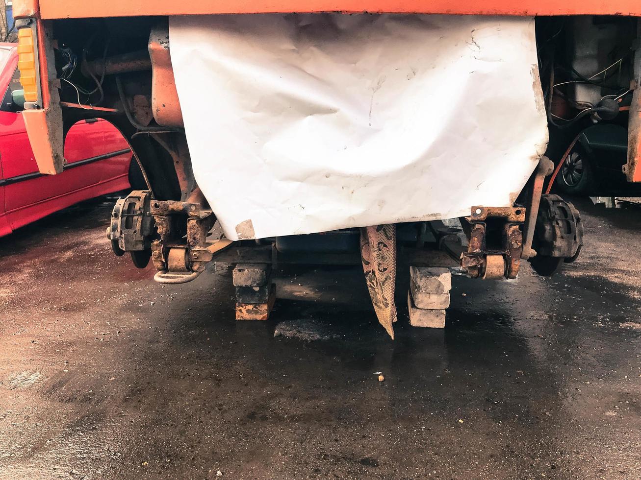 Repair of the old truck, minibus, car on the street. Car suspension repair. Replacing wheel photo