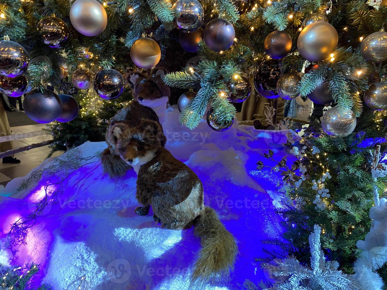 Christmas and New Year Decoration. Musical ensemble of toy foxes under the Christmas tree. New Year concepts photo