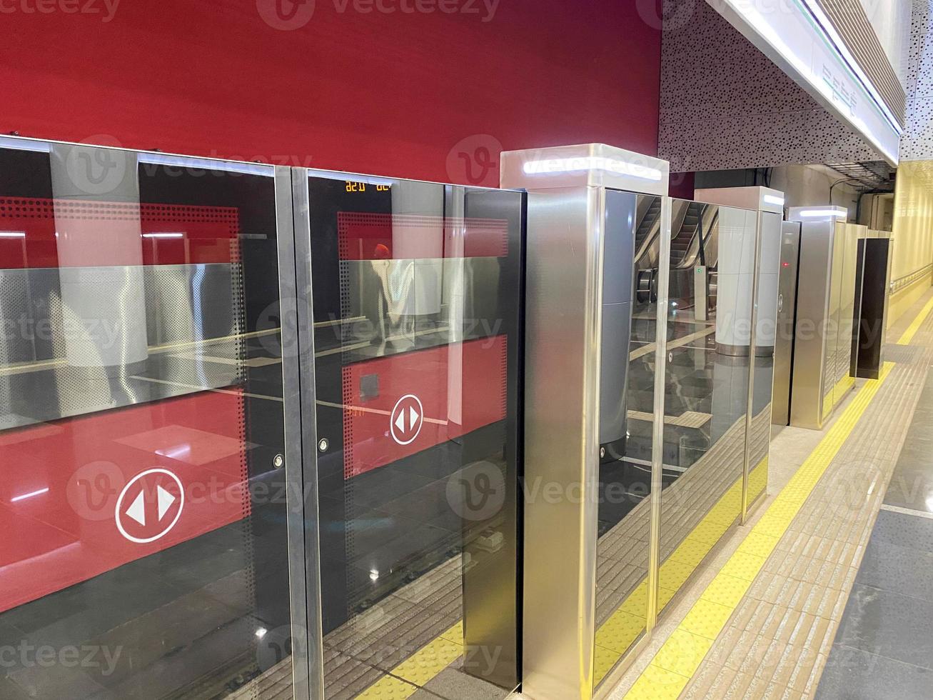 Automatic door platform system at a new modern metro station. Metro security system glass beautiful doors open synchronously with the doors of the arriving train car photo