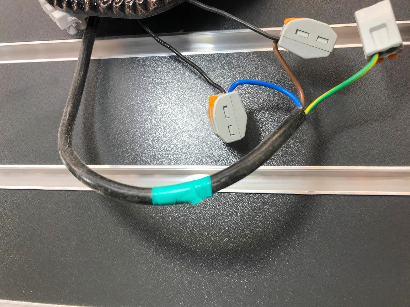 electrical wires in the lamp. wires wrapped with electrical tape at the break points. independent electrical connection, plastic boxes on wires photo
