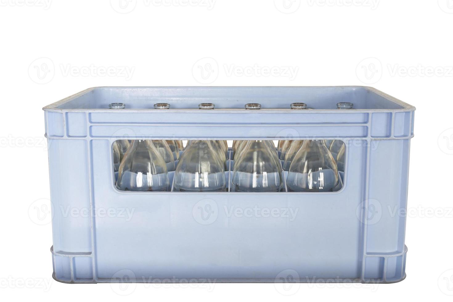Bottle of water in a crate isolated on white background with clipping path photo