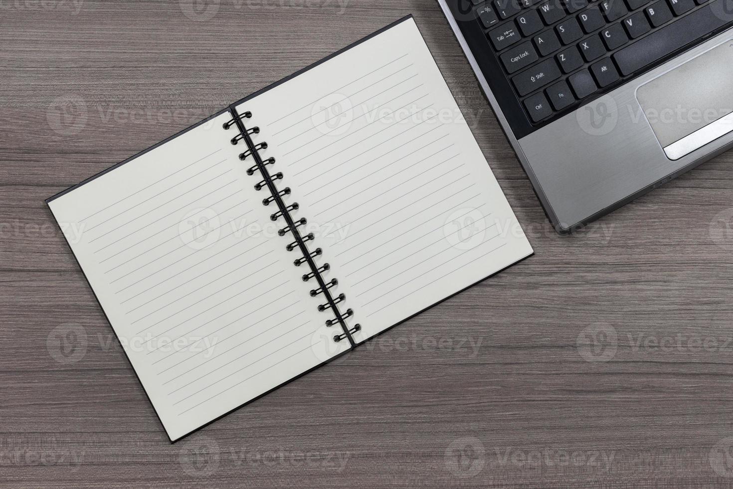 Top view notebook and laptop on wood table photo
