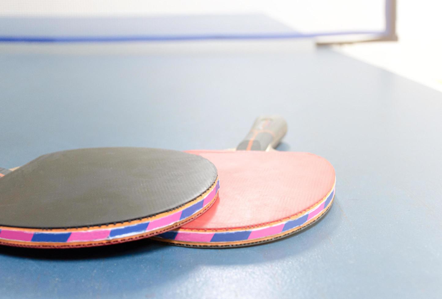Ping pong rackets and balls on table photo