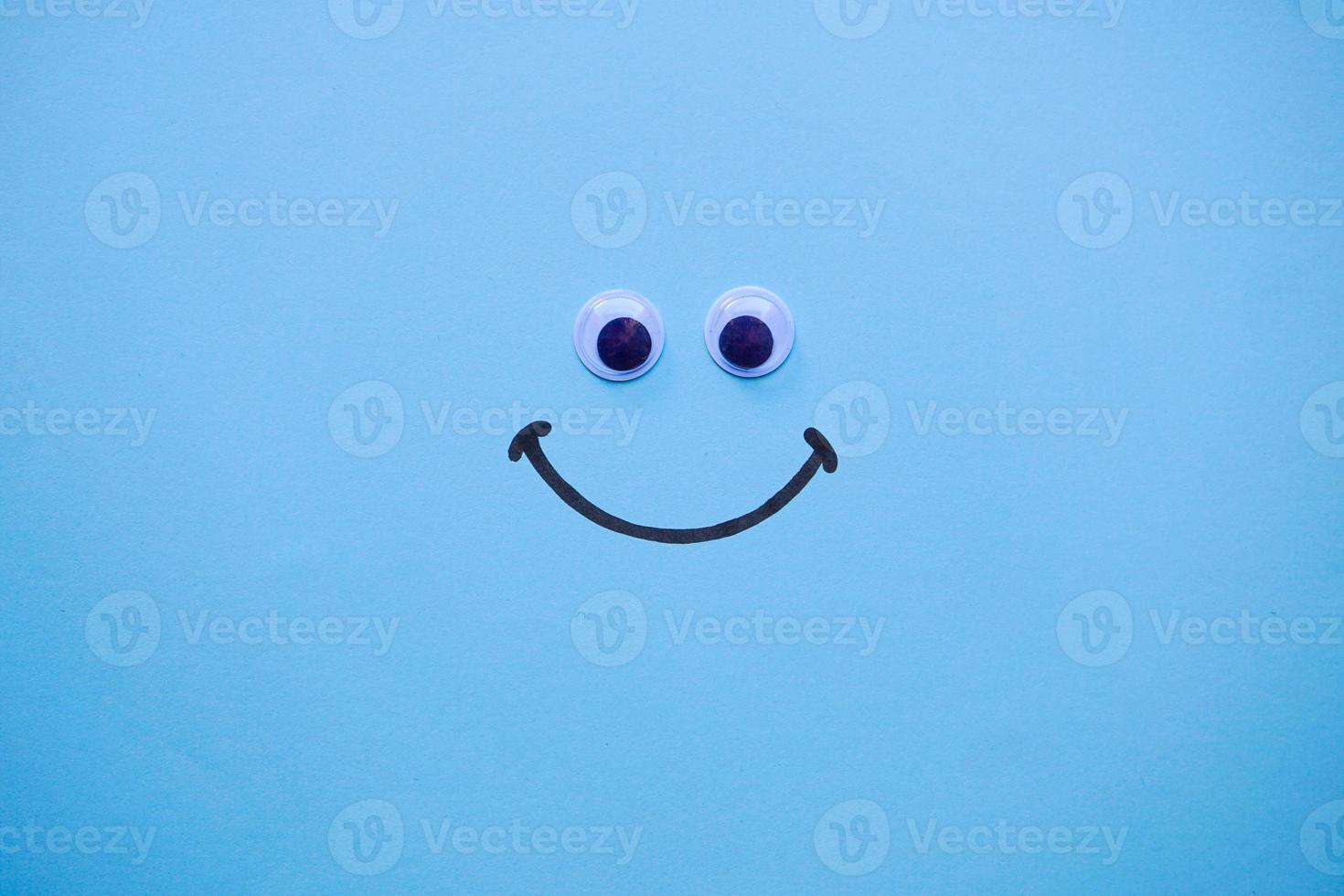 smile emotion on the blue background photo