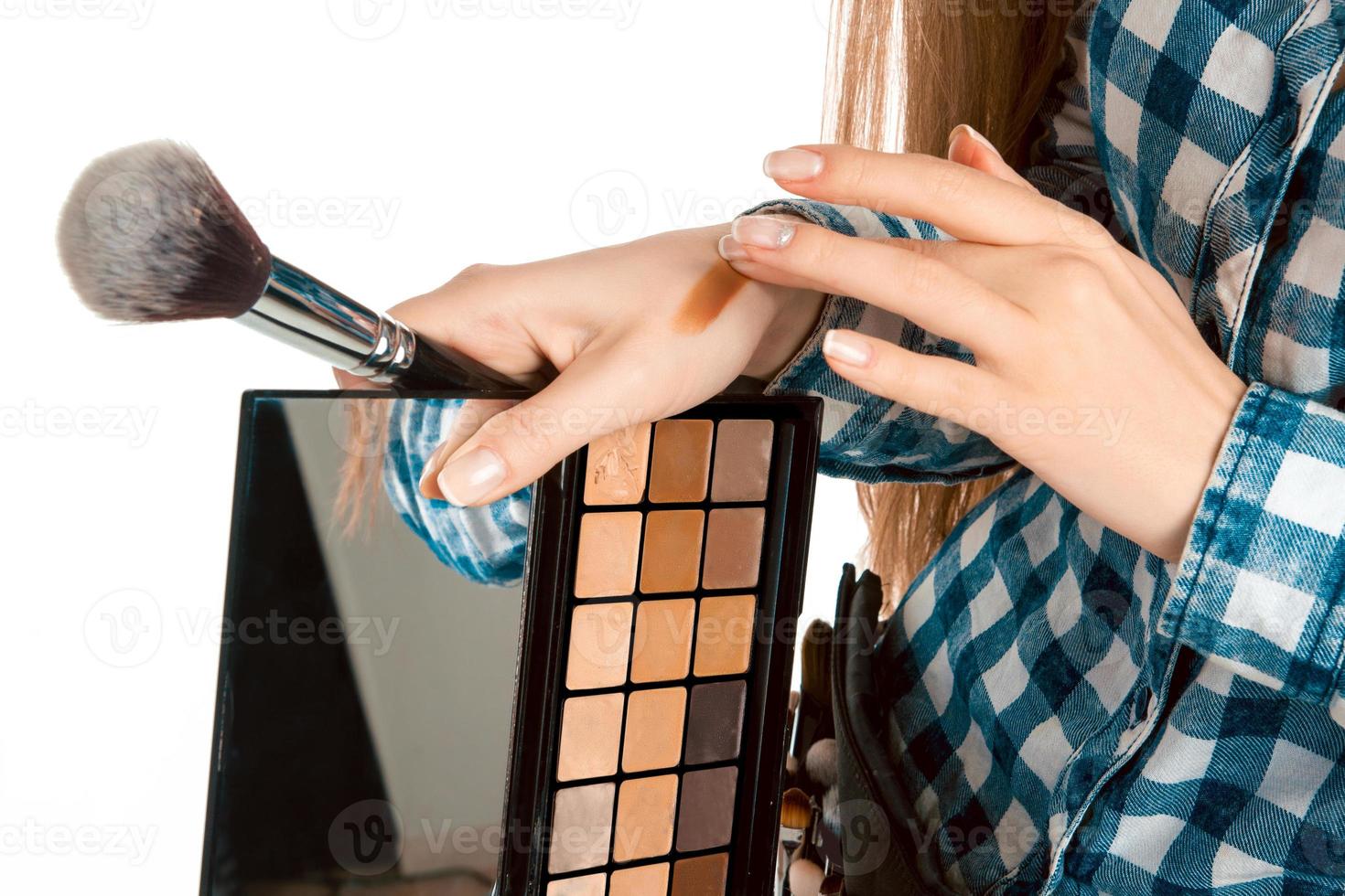 Girl testing foundation on hand photo