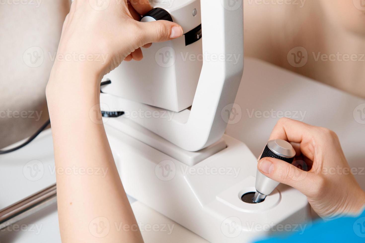 close up Photo of female hands working on the ophthalmic device