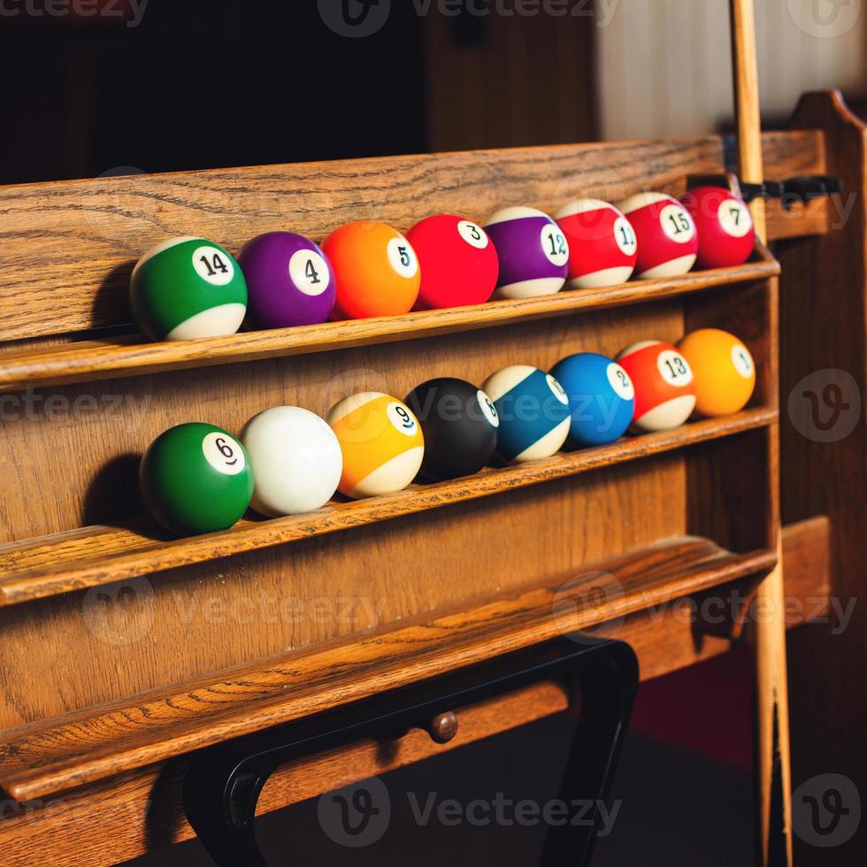 Square photo Set of balls for a game of pool billiards on shelves