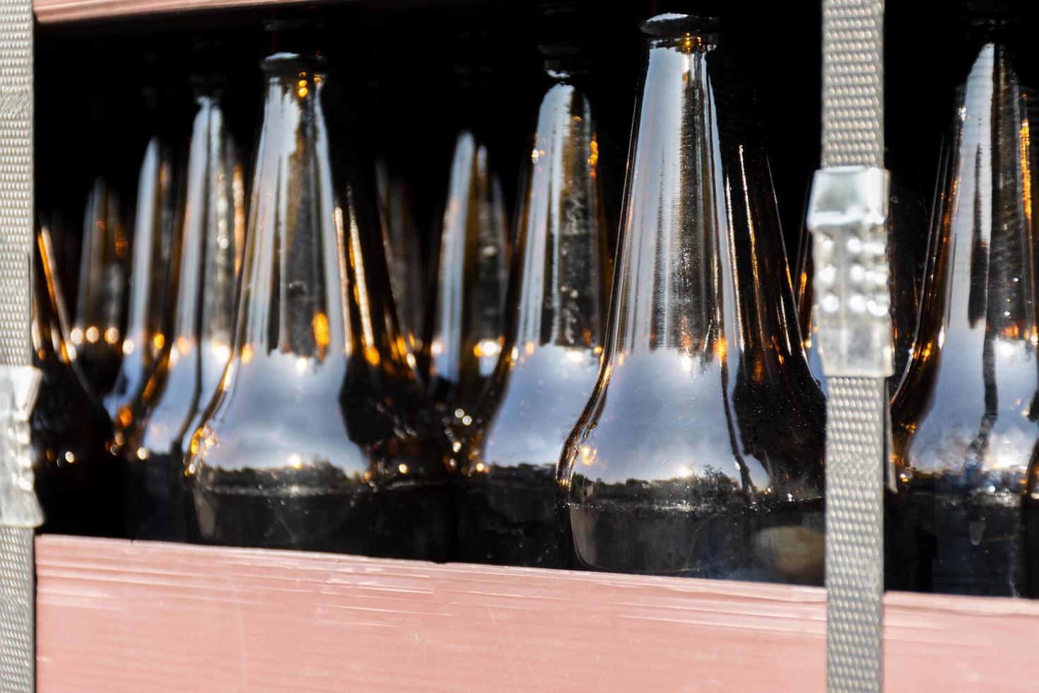 Close up beer bottle in pallet for brewing in industrial plants photo