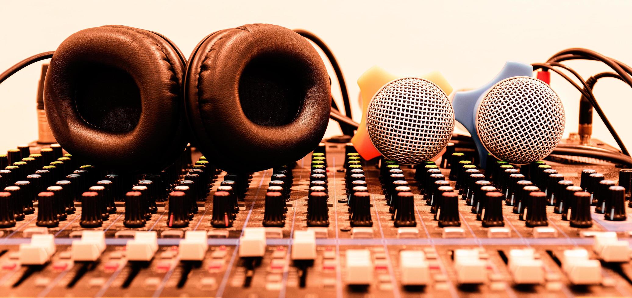 Black headphone and two microphone on console sound board mixer photo