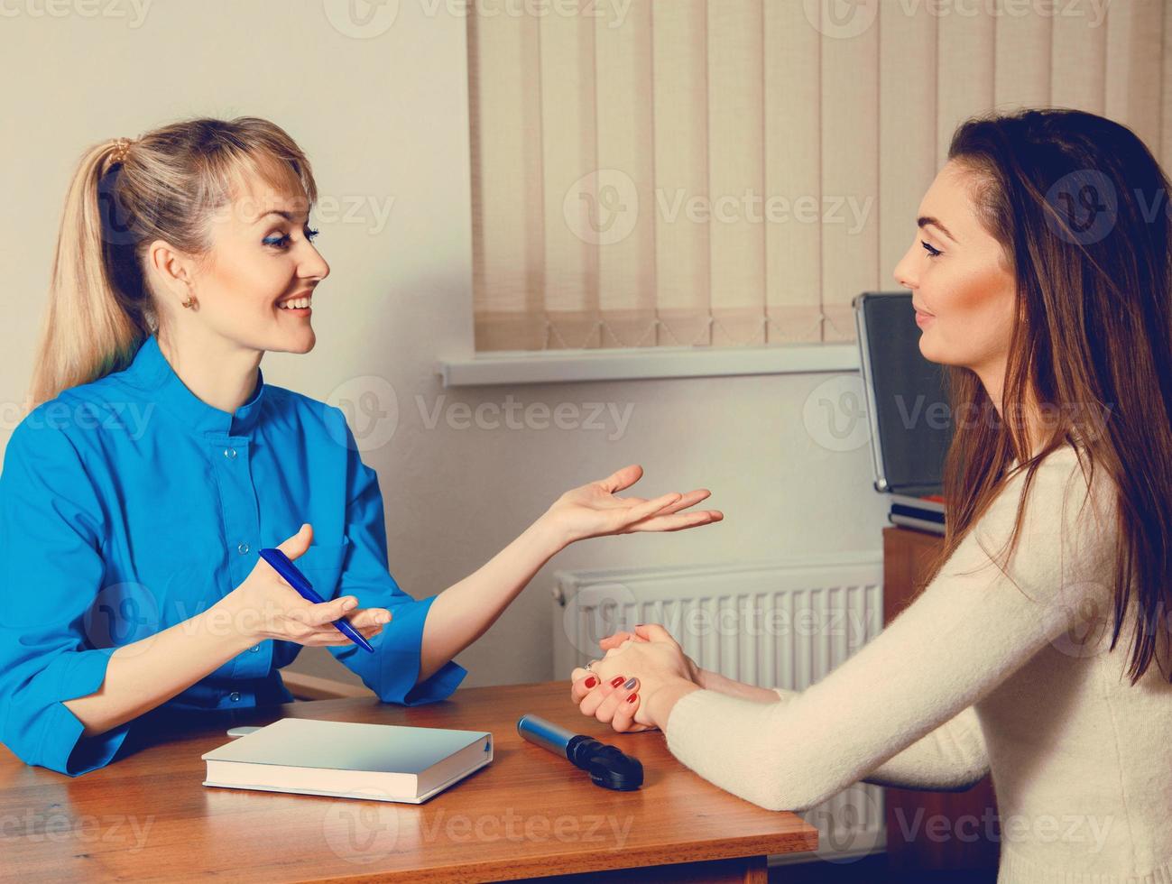doctor has fun with her patient at consultation photo