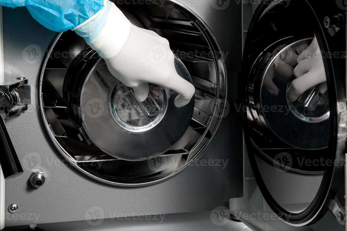Doctor hand in latex glove sterilizes items for surgery photo