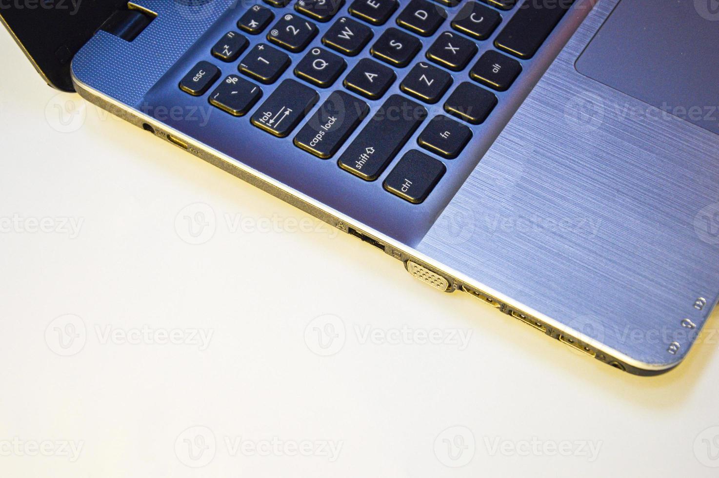 side view left side of laptop on a white background and using yellow-orange light photo