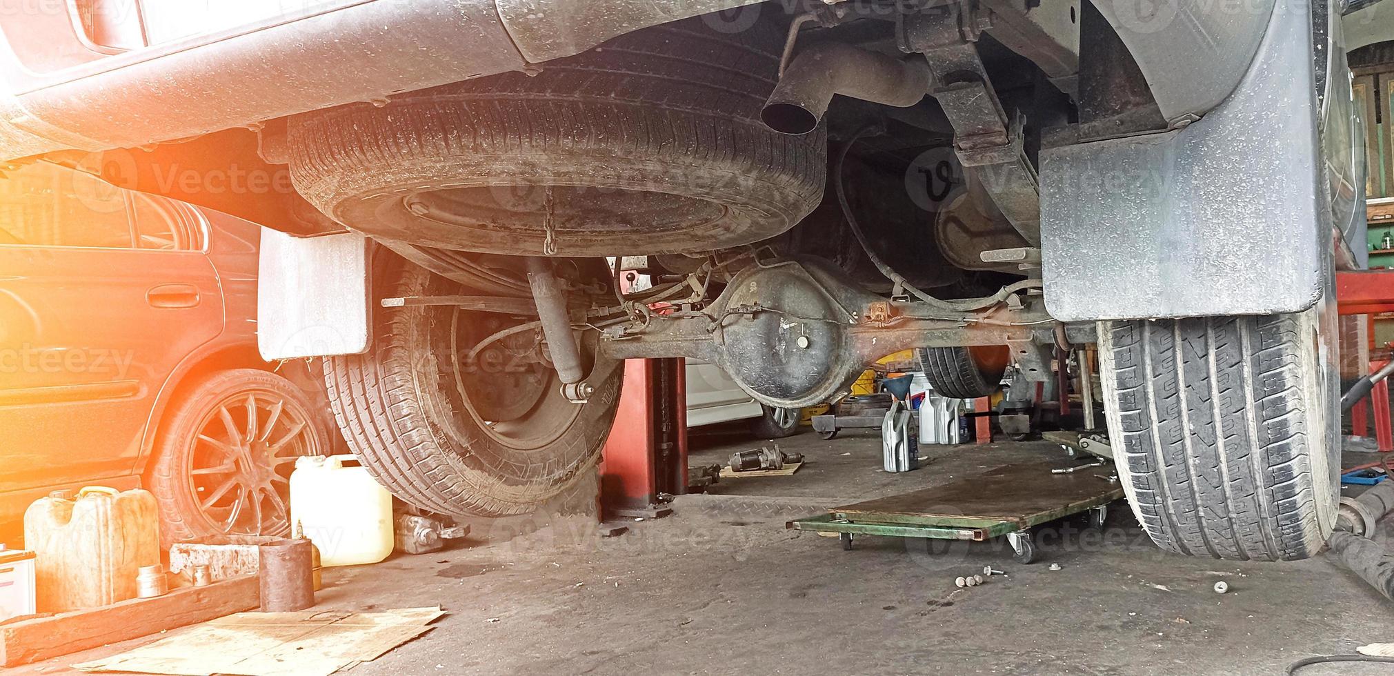 rear of pickup truck that was lifted off the ground to prepare for repair photo