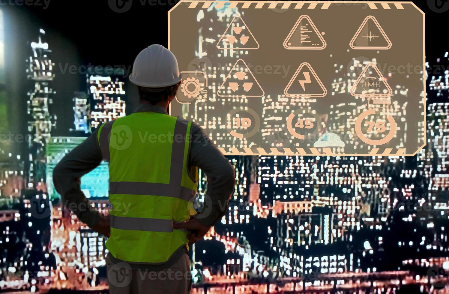 Engineer standing in front of a beautiful night city view. And there is a semi-transparent icon floating on the right side. photo