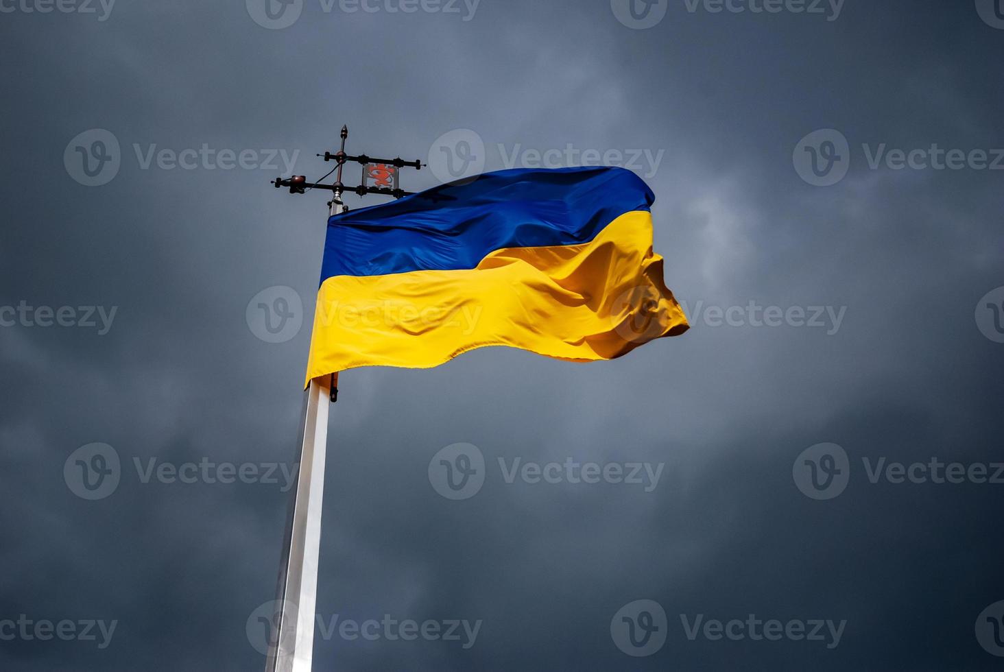 Yellow-blue national flag of Ukraine with stormy sky background photo