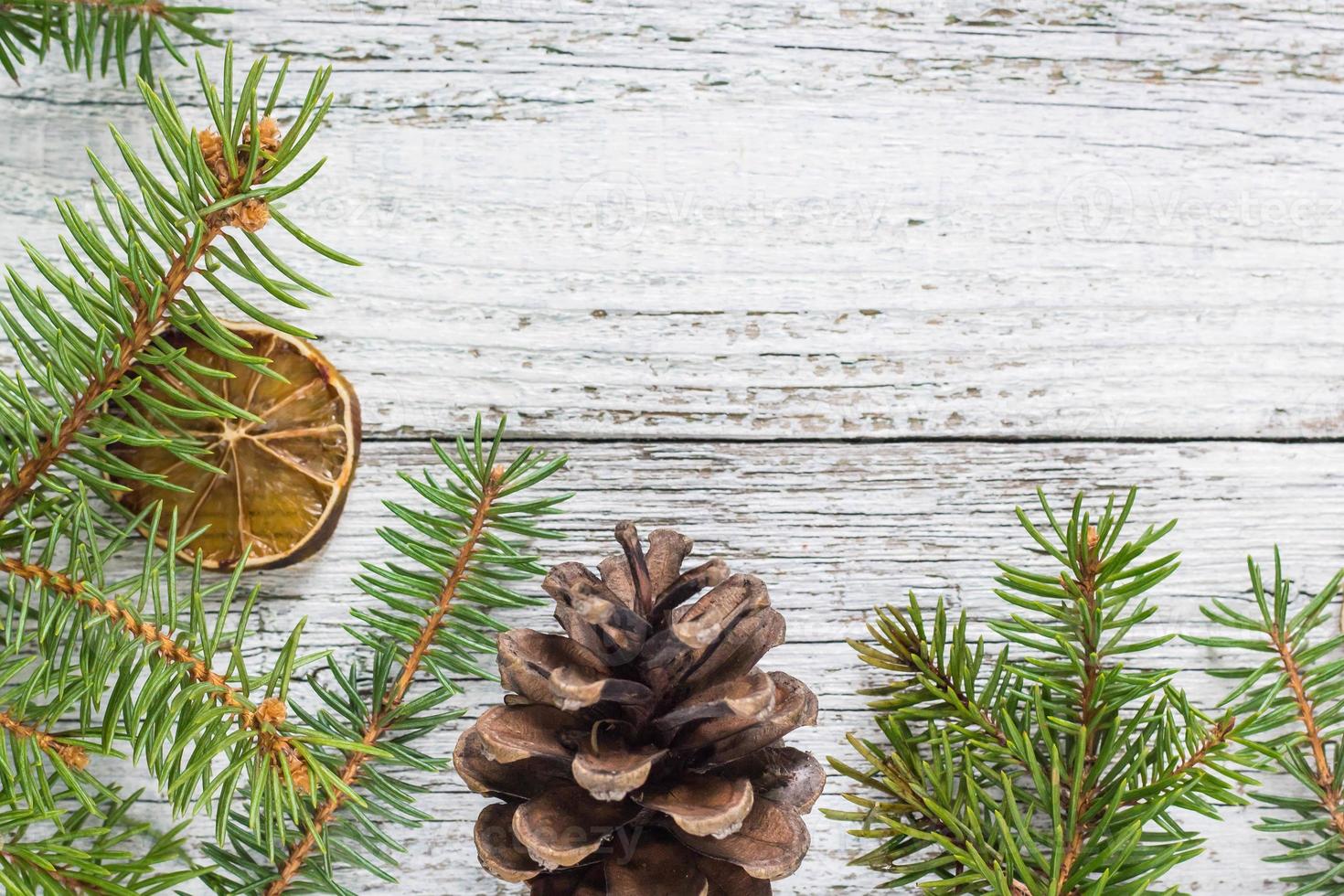 Christmas fir branches with cones and dry lemon slice photo