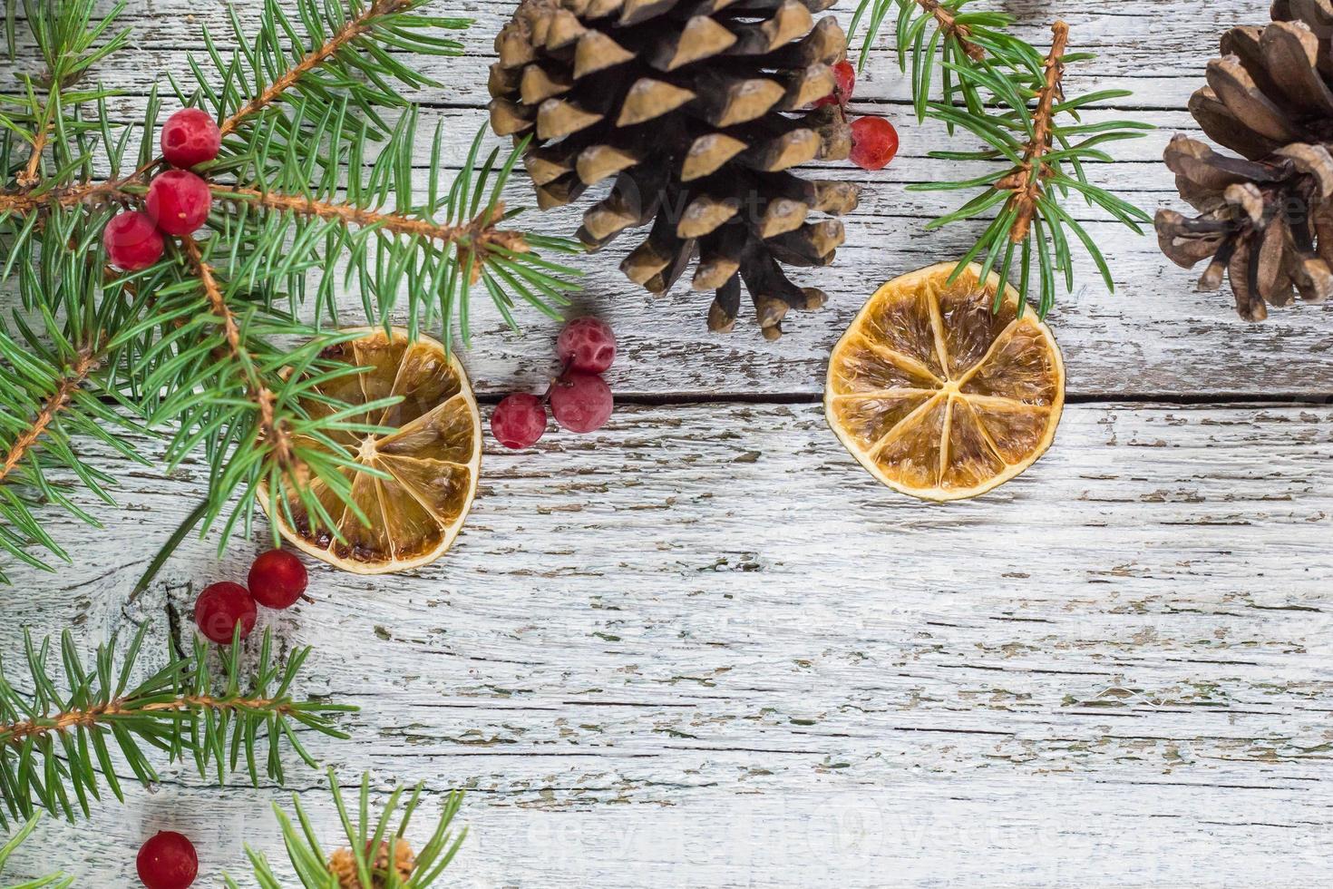 Christmas branches with cones viburnum berries and dry lemon slice photo