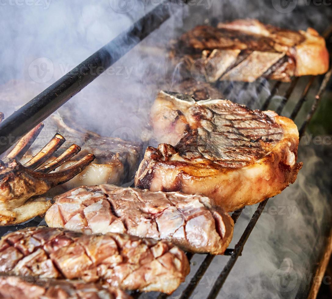 Lamb ribs and steaks are cooked on the grill for serving in catering photo