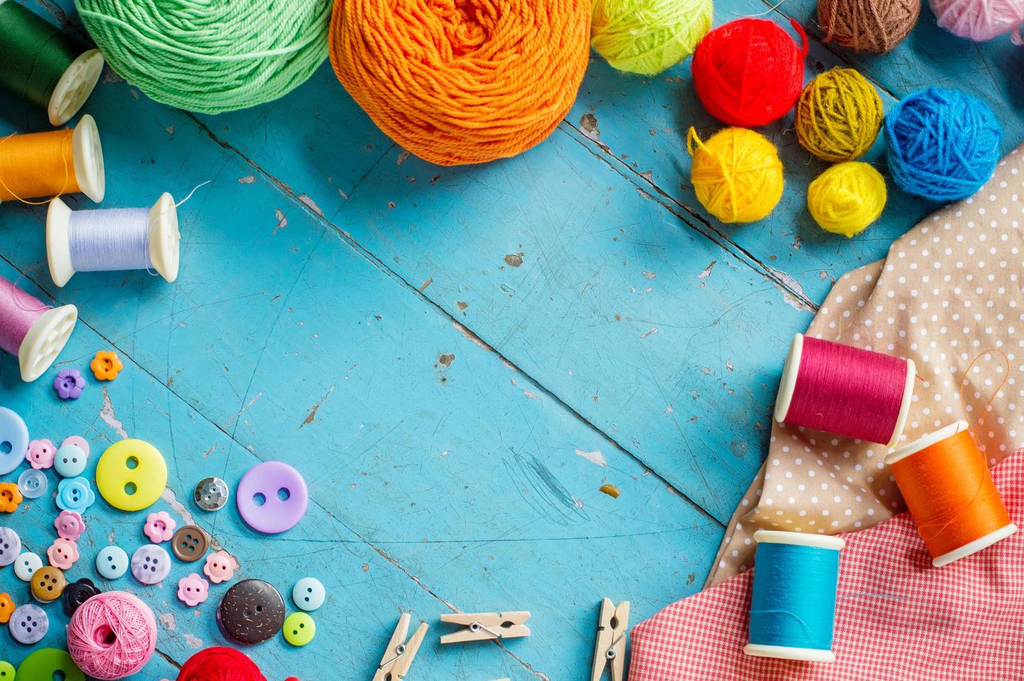 Sewing background. Accessories for needlework on old wooden background. photo
