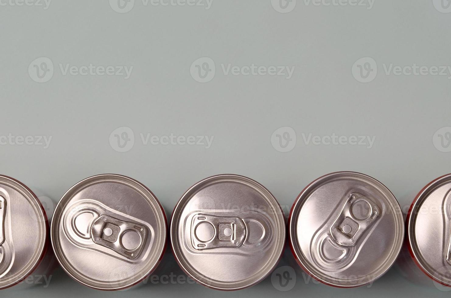 Many new aluminium cans of soda soft drink or energy drink containers. Drinks manufacturing concept and mass production photo