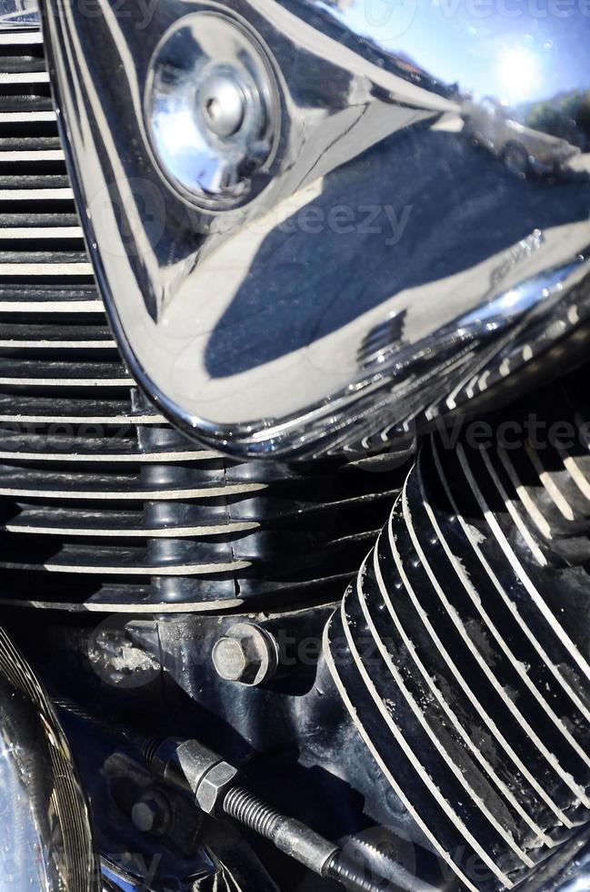 Fragment of chromed shiny body part of old classic motorbike photo