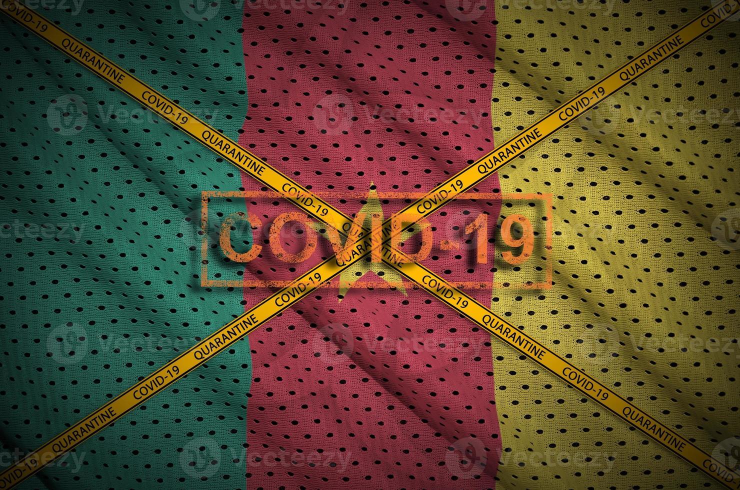 Cameroon flag and Covid-19 stamp with orange quarantine border tape cross. Coronavirus or 2019-nCov virus concept photo