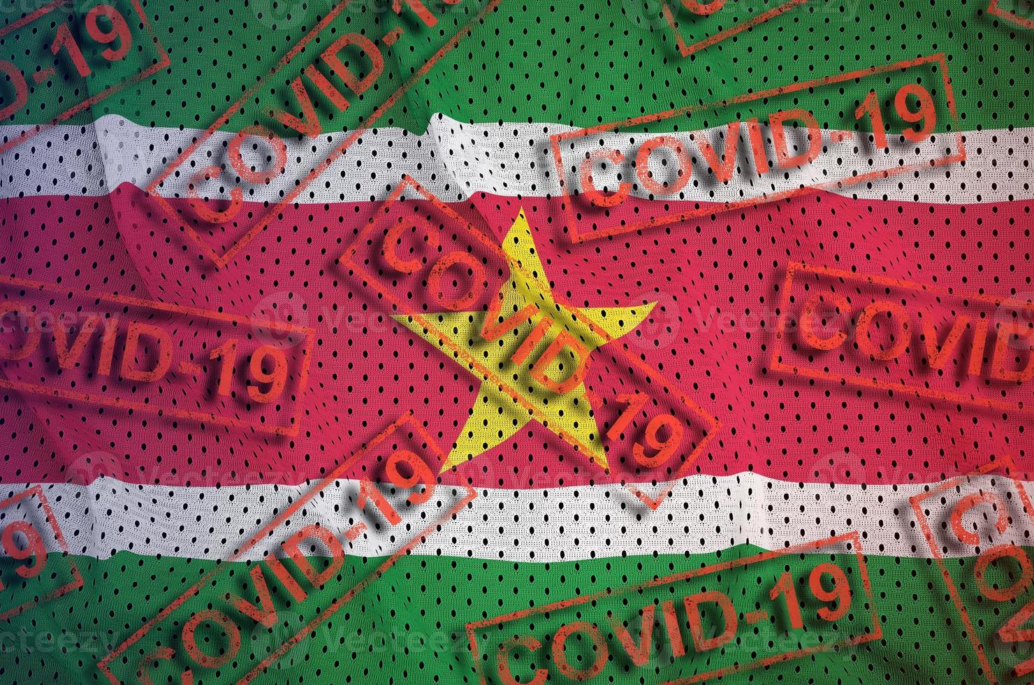 Suriname flag and many red Covid-19 stamps. Coronavirus or 2019-nCov virus concept photo