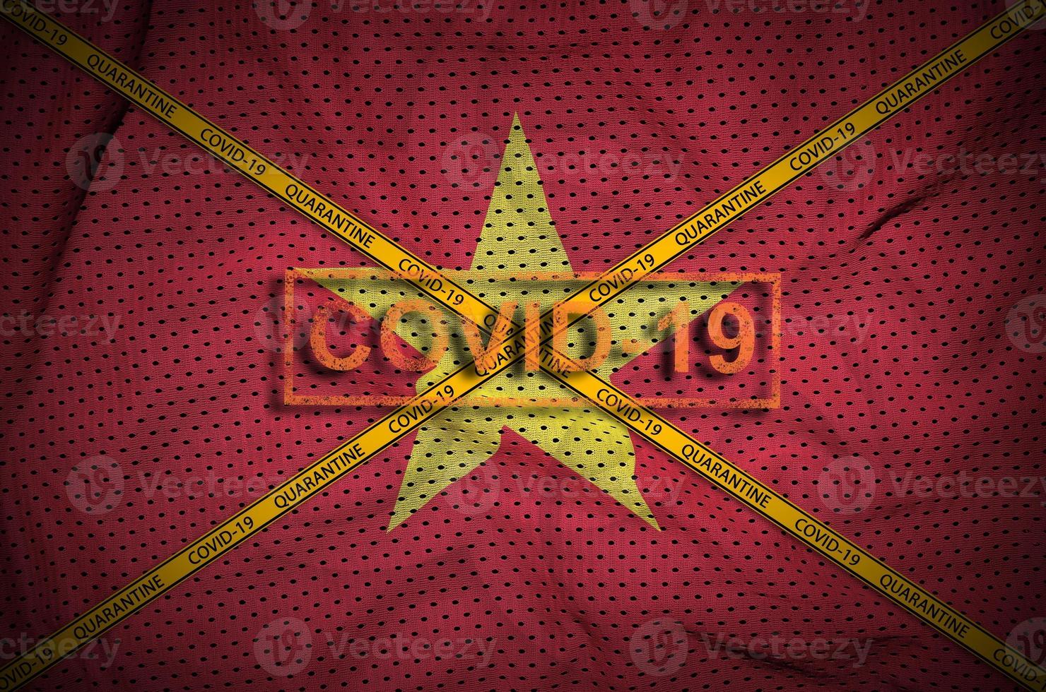 Vietnam flag and Covid-19 stamp with orange quarantine border tape cross. Coronavirus or 2019-nCov virus concept photo