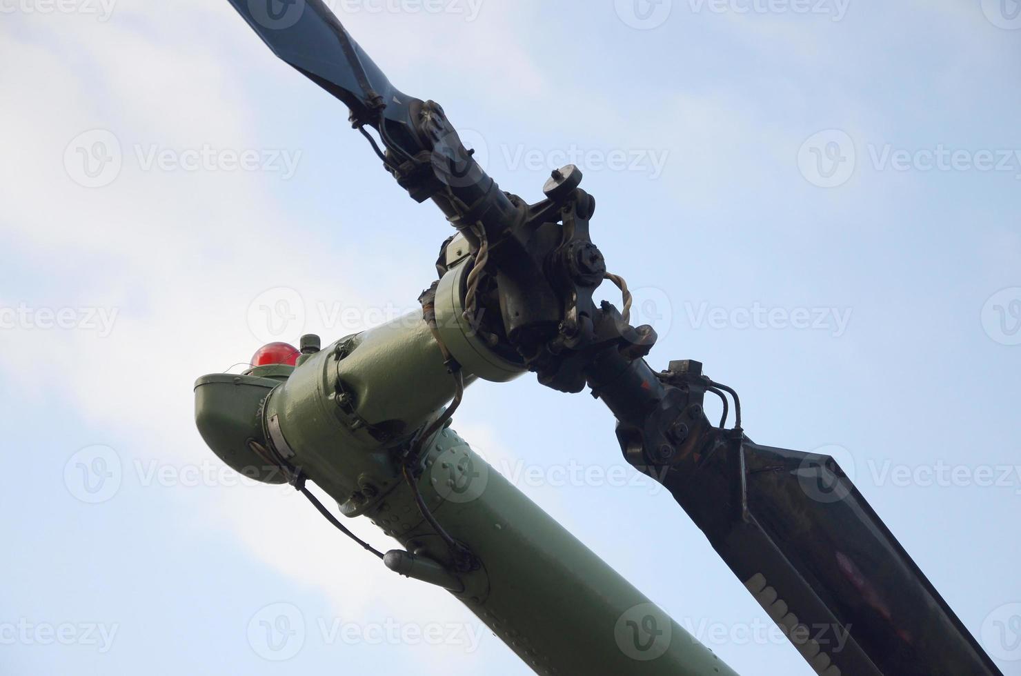 Tail rotor of armoured military helicopter close up against blue sky background photo