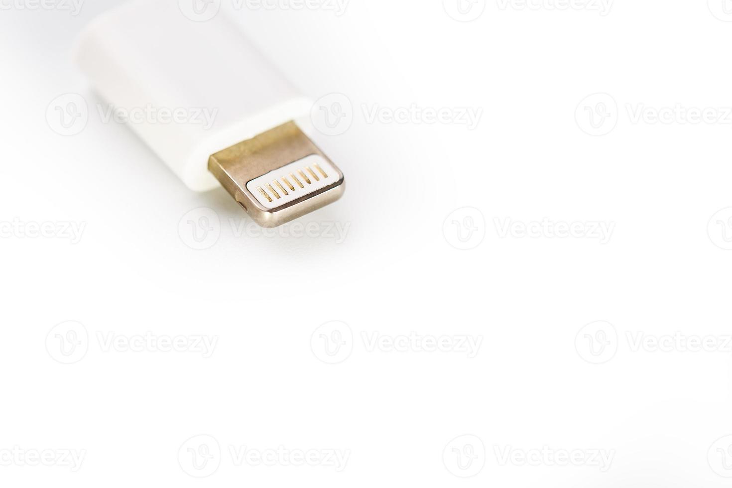 Connector lightning on a white background. This is a proprietary connector used to connect mobile devices to well-known host computers photo