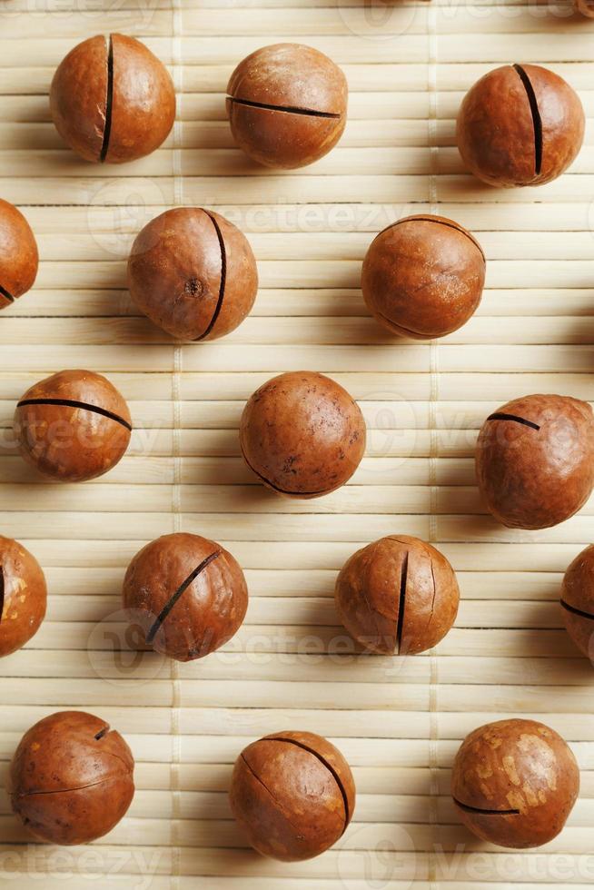 Macadamia nuts are made up of patterns on a bamboo light background. Patterns, repeats, texture and background photo