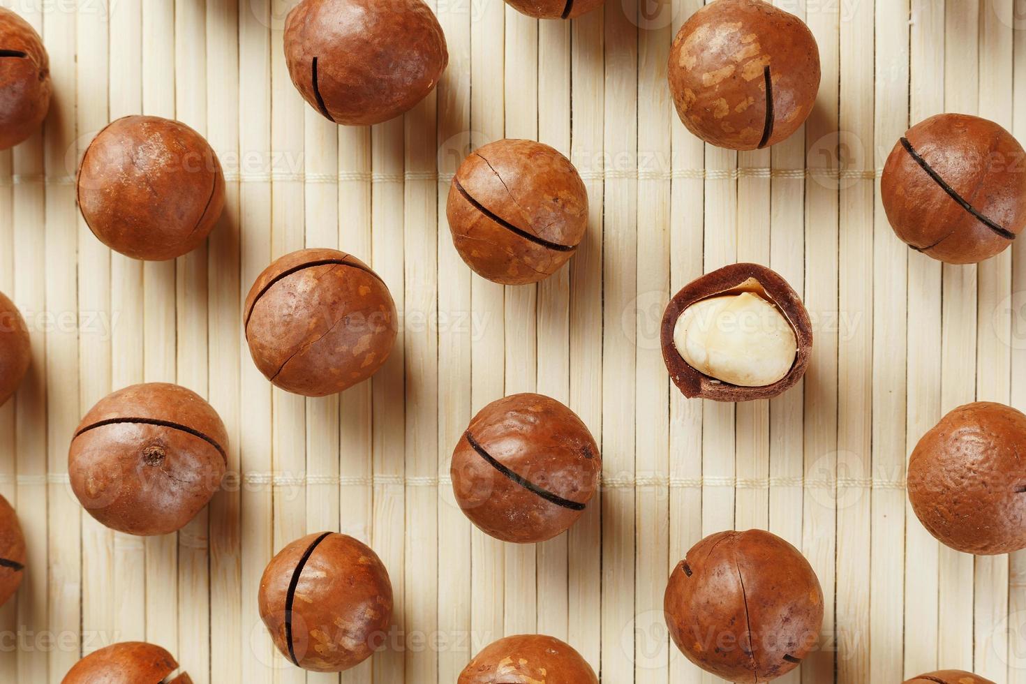 Macadamia nuts are made up of patterns on a bamboo light background. Patterns, repeats, texture and background photo