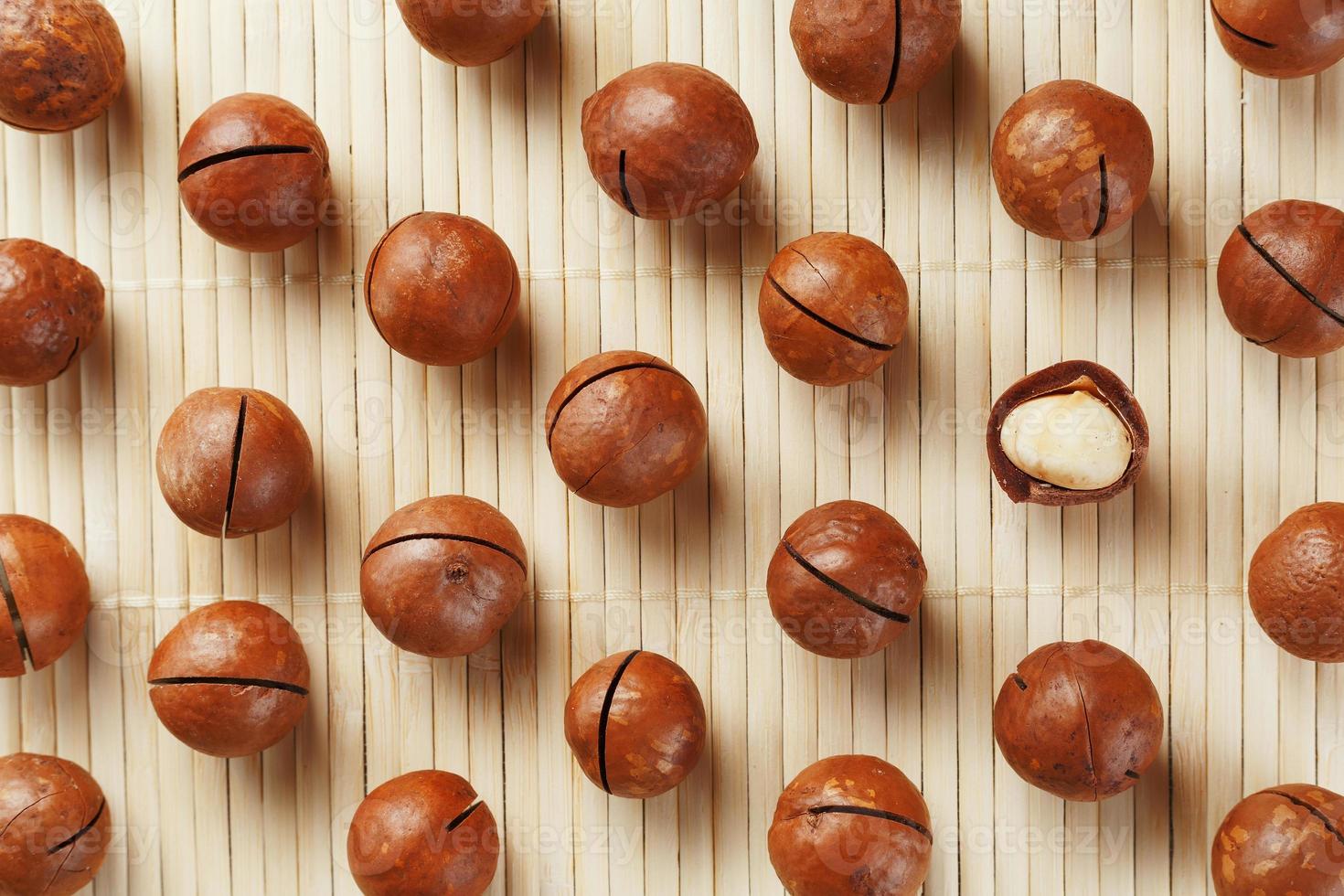 Macadamia nuts are made up of patterns on a bamboo light background. Patterns, repeats, texture and background photo