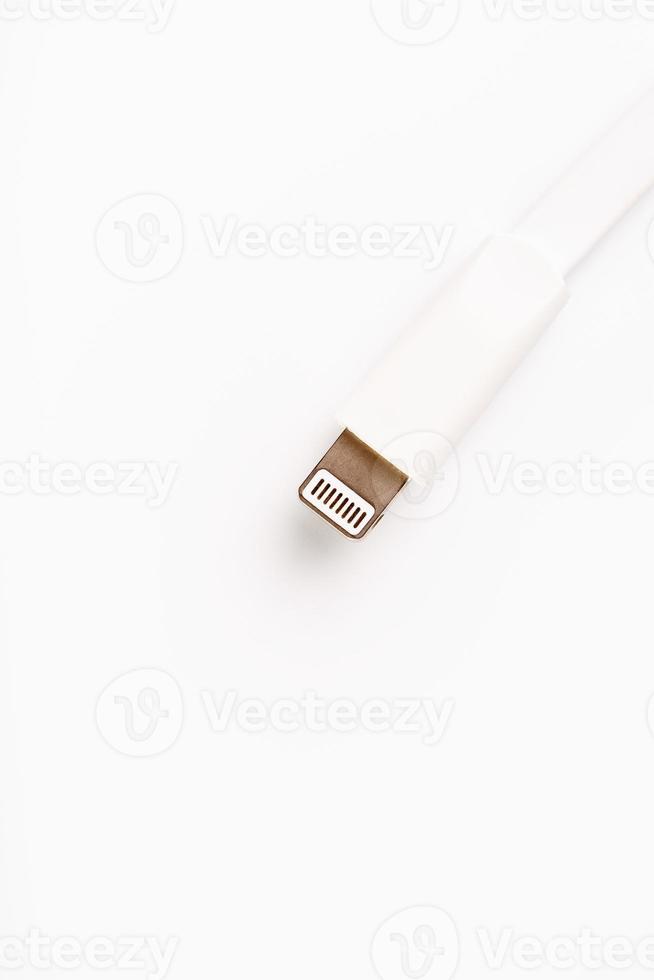 Connector lightning on a white background. This is a proprietary connector used to connect mobile devices to well-known host computers photo