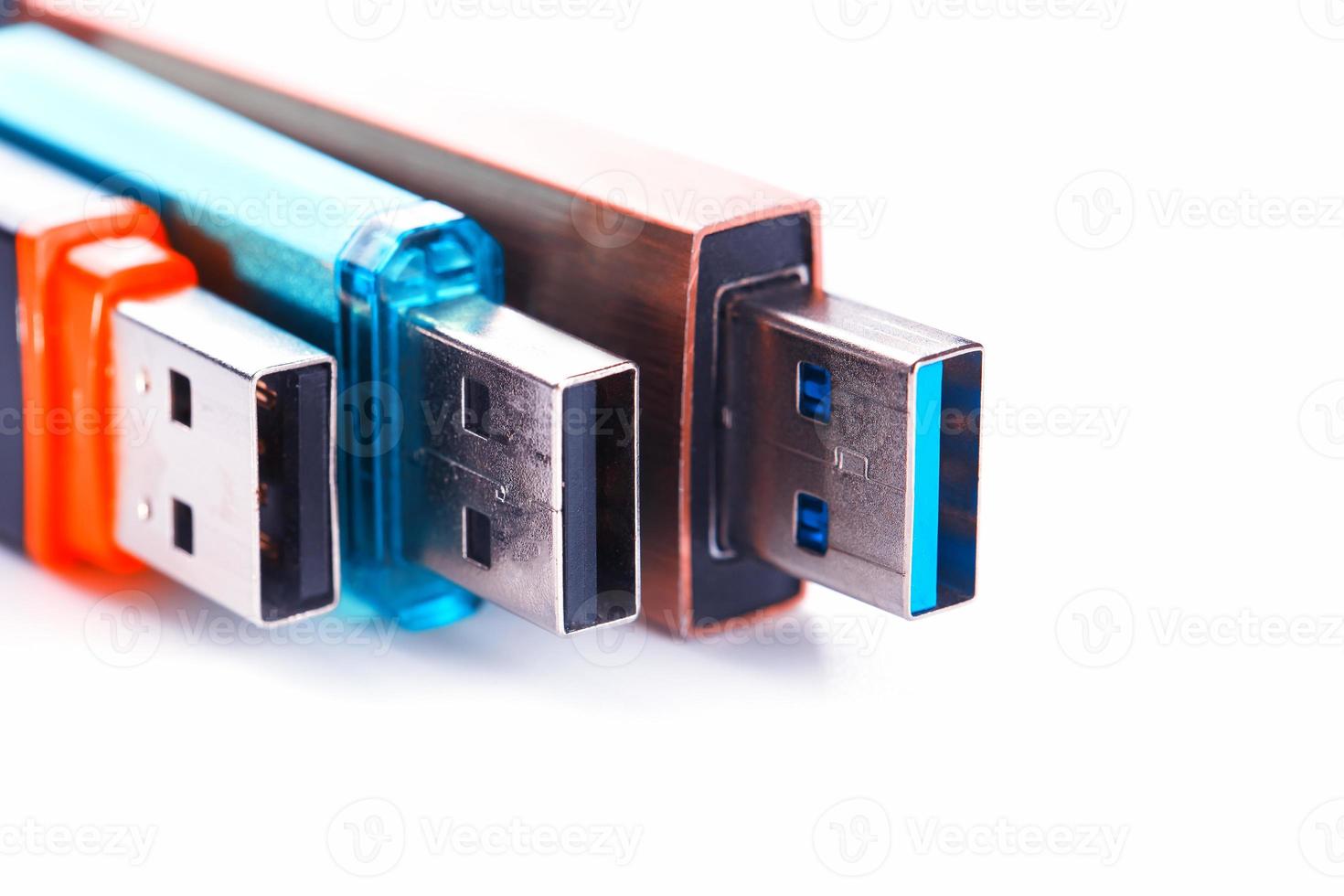 Detailed view of a black USB flash drive with a silver-blue connector. Photo on a white background