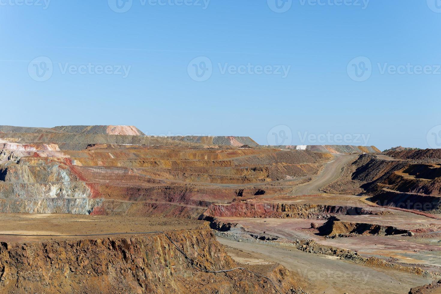 View of Mining activity in Minas de Riotinto in Spain. Apocalypse scenery. Mining village in Andalusia. Earth destruction. Disruption of nature. Extracting natural resources from the Earth. photo