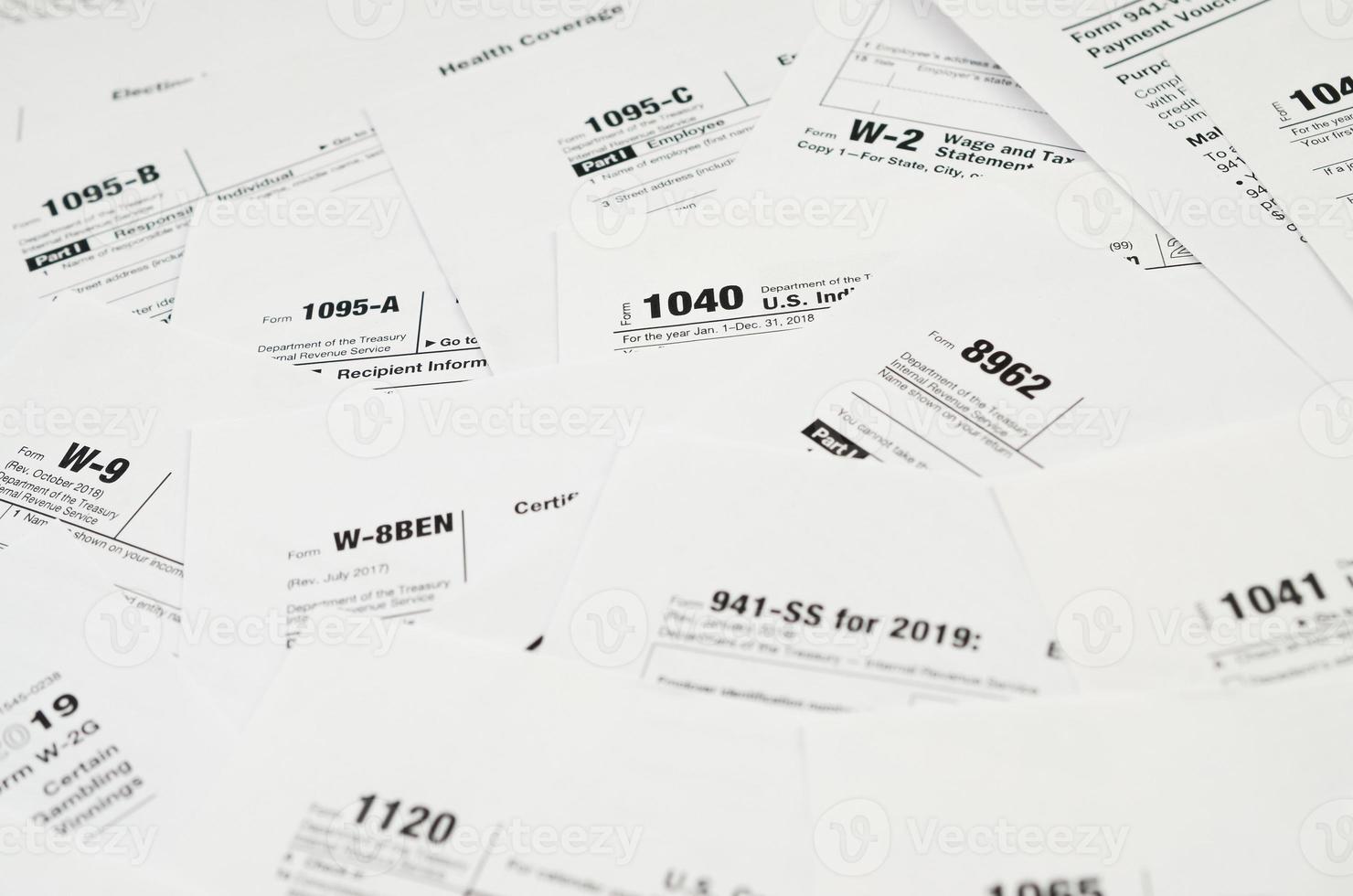 Many tax form blanks lies on table close up. Tax payers paperwork routine and bureaucracy concept photo