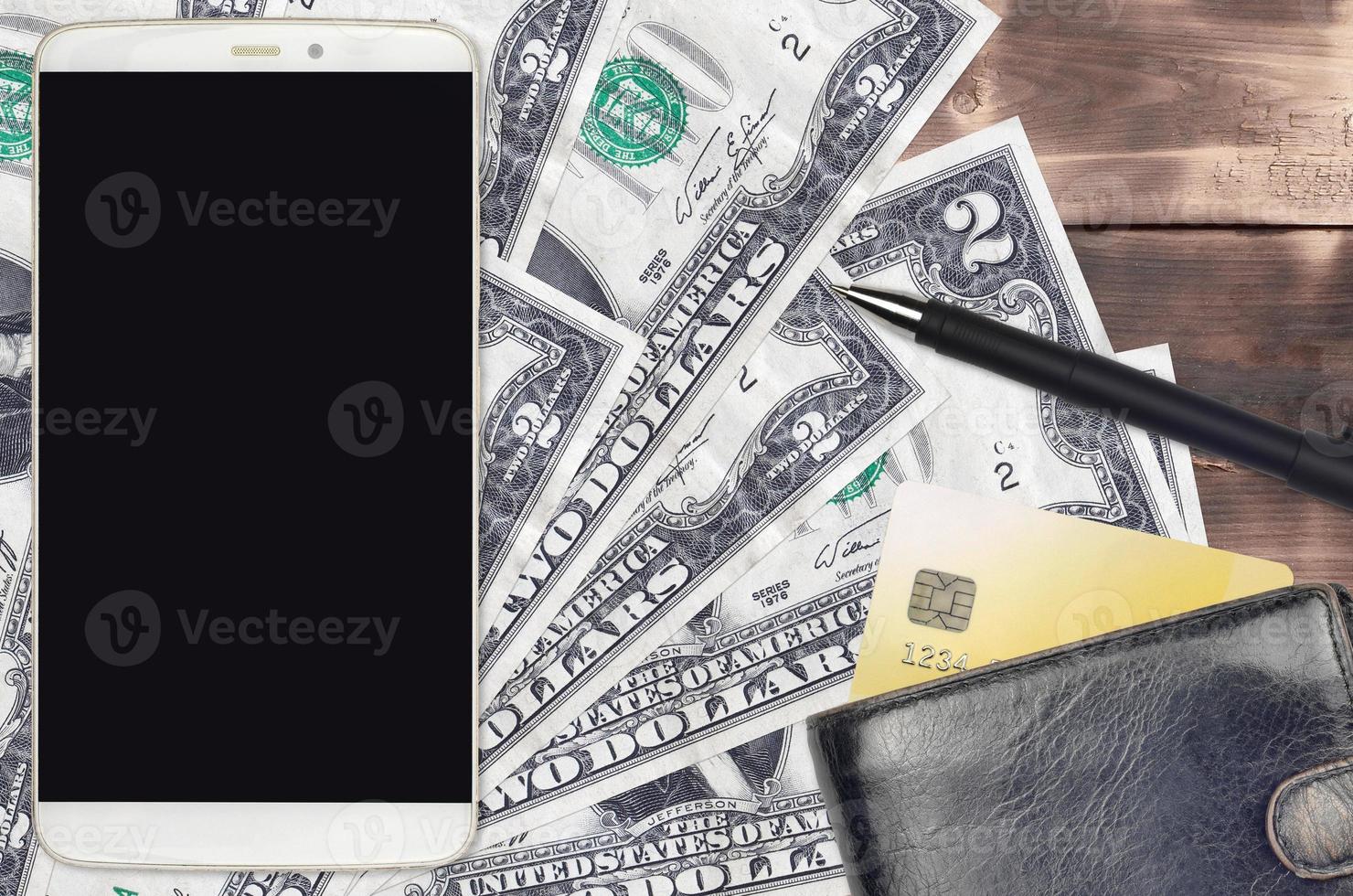 2 US dollars bills and smartphone with purse and credit card. E-payments or e-commerce concept. Online shopping and business with portable devices photo