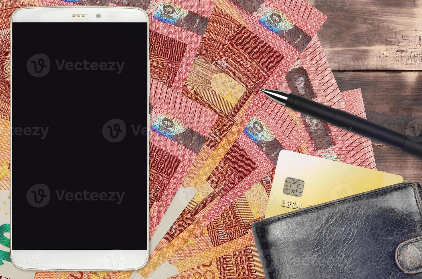10 euro bills and smartphone with purse and credit card. E-payments or e-commerce concept. Online shopping and business with portable devices photo