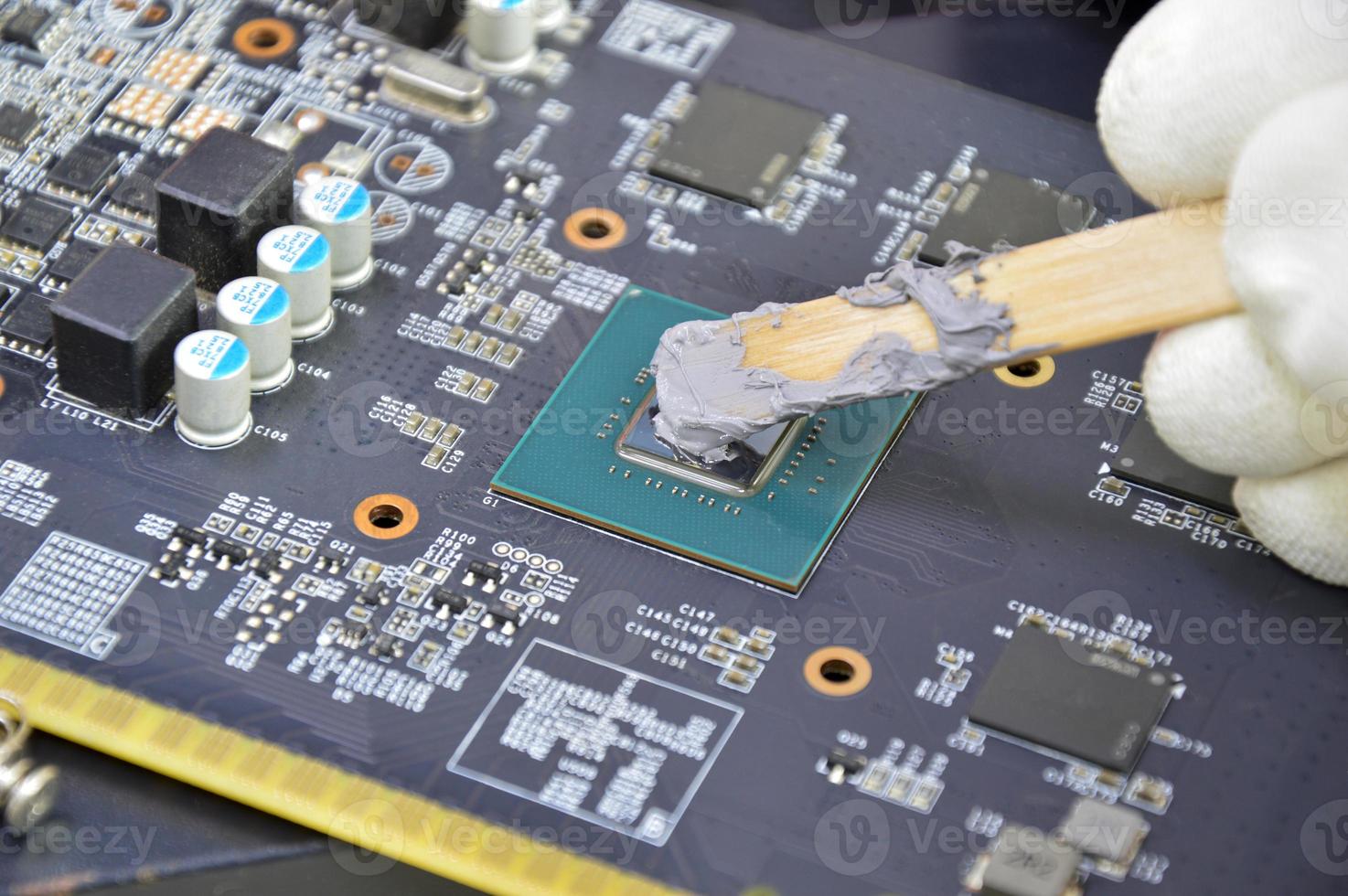 The image of a technician filling a silicon cooling chip CPU. photo