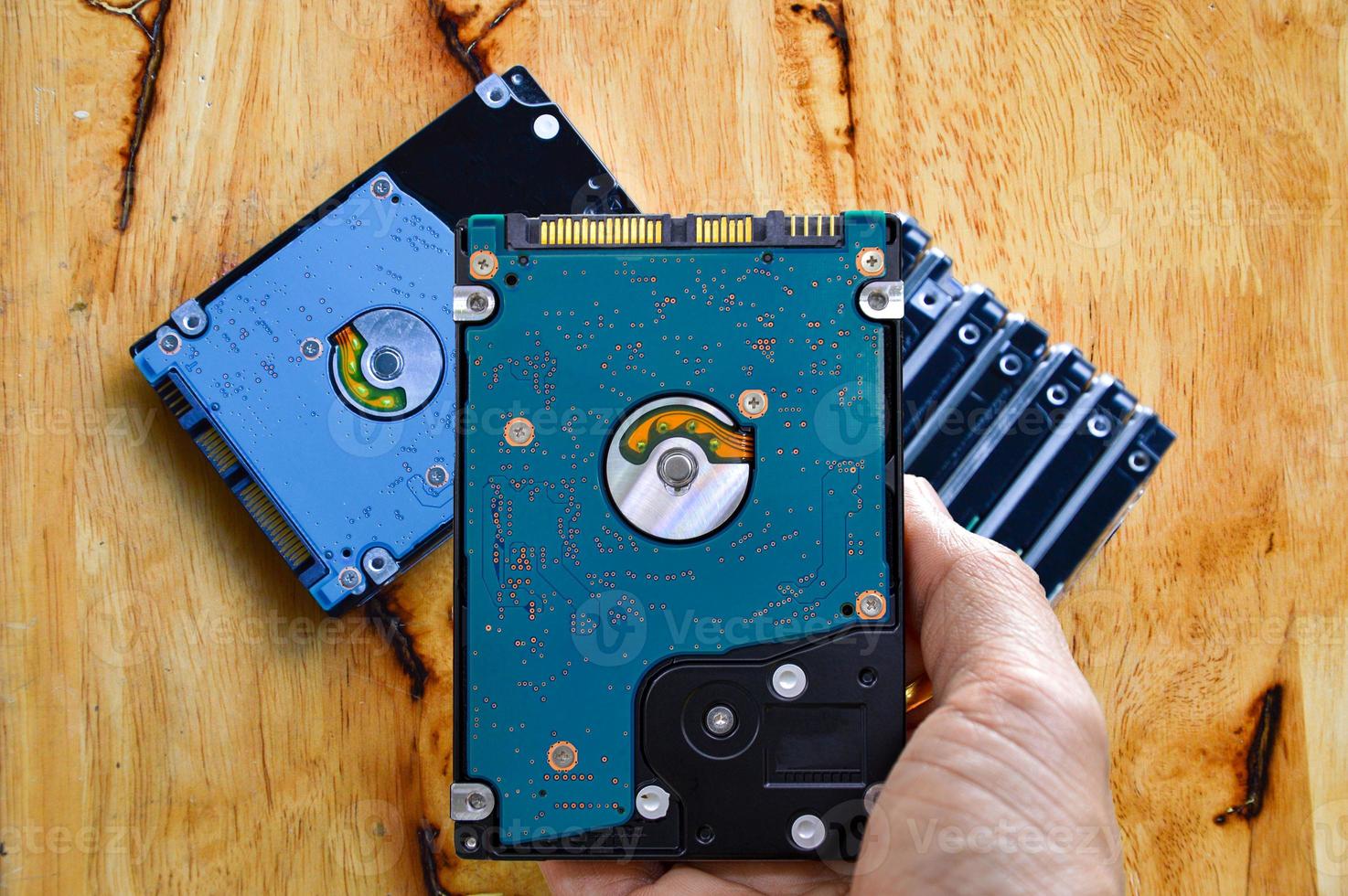 Hard disk drives are still widely used. hard drive in hand photo