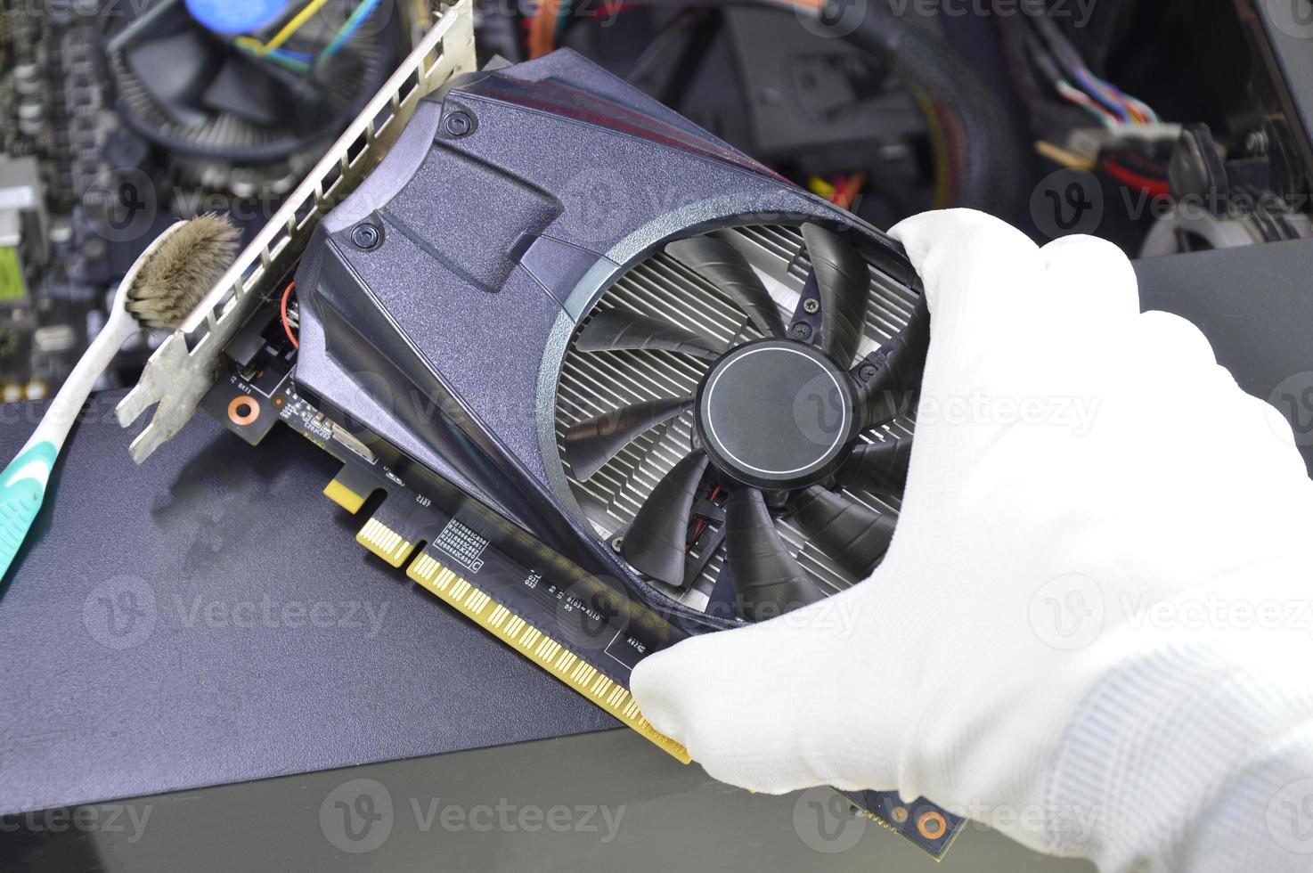 top view of graphics card technician about to install photo