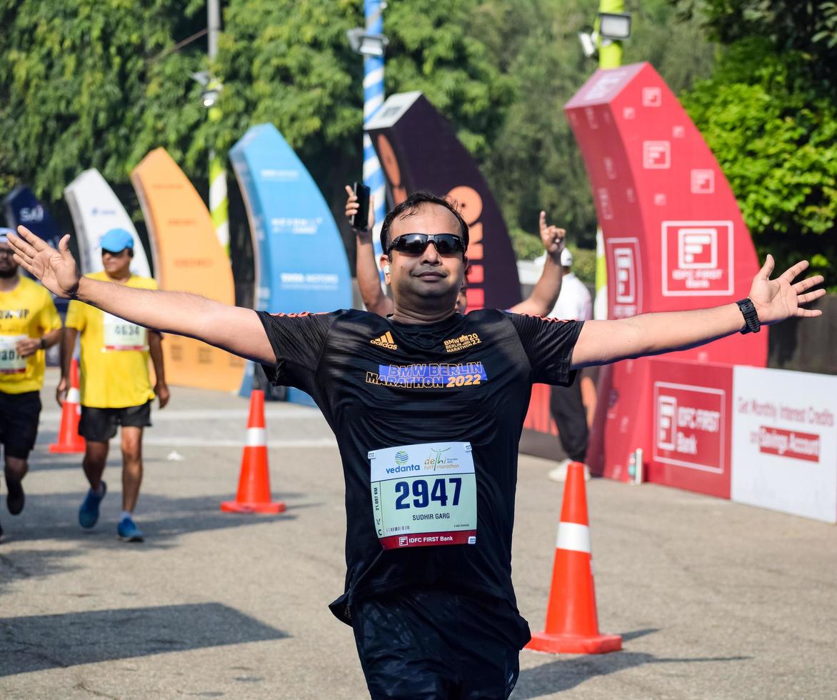 New Delhi, India - October 16 2022 - Vedanta Delhi Half Marathon race after covid in which marathon participants about to cross the finish line, Delhi Half Marathon 2022 photo