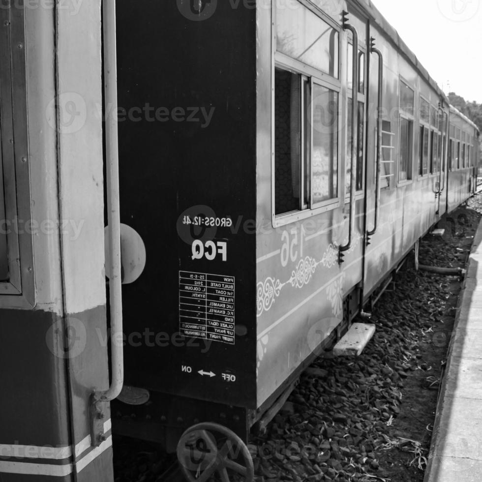 Toy Train moving on mountain slope, beautiful view, one side mountain, one side valley moving on railway to the hill, among green natural forest.Toy train from Kalka to Shimla in India-Black and White photo