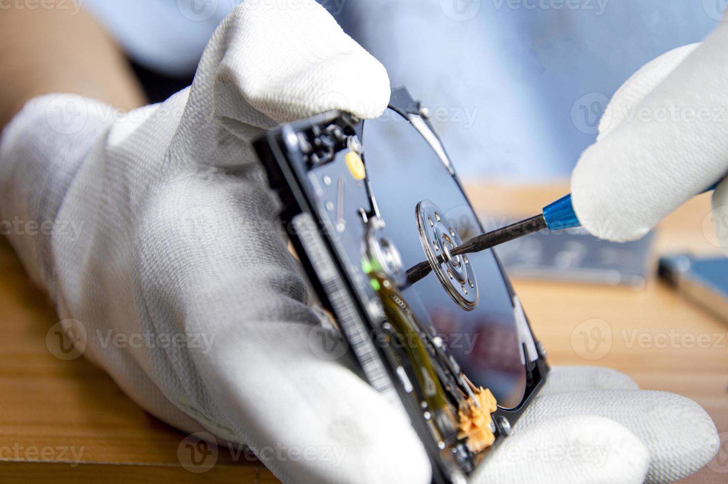 mechanic repairing hard drive, hard drive It is a device for storing data. photo
