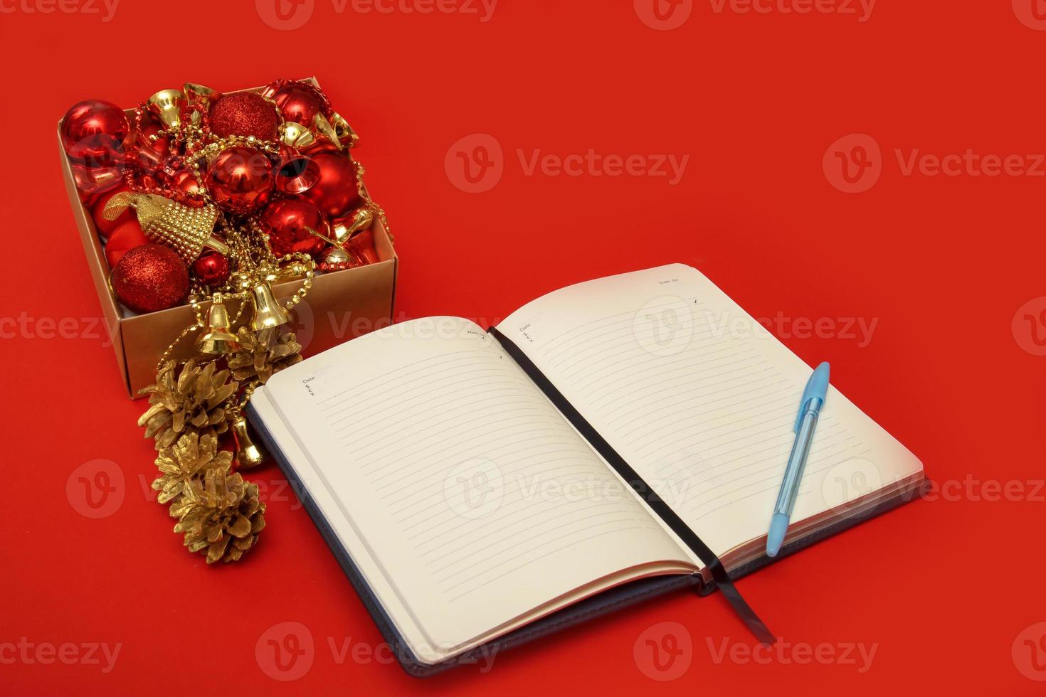 open blank notebook next to a box of new year toys, the concept of new goals in the new year photo